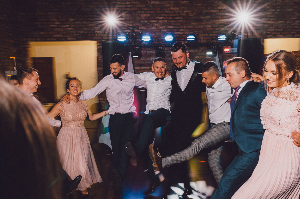 Pan młody oraz goście tańczą razem na przyjęciu weselnym w Chacie Baranowskiej.
